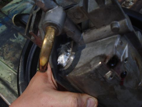 1994 Ford F-350 - Close-up of an engine component, possibly a carburetor, with a visible repair and brass tubing.