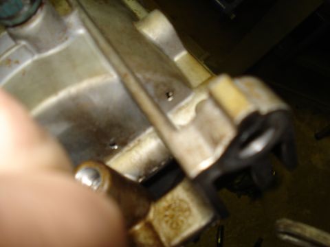 1994 Ford F-350 - A close-up view of a greasy engine part with a black plastic bracket. The year is not discernible.