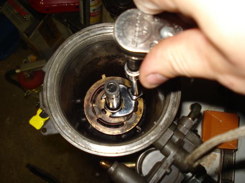 1994 Ford F-350 - Mechanic uses a ratchet wrench to adjust a component within a vehicle's distributor cap.