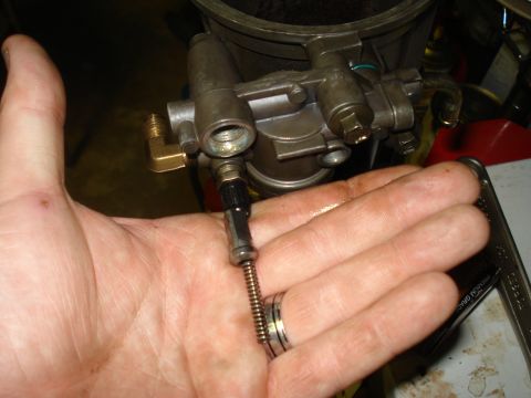 1994 Ford F-350 - A person holds a fuel filter housing assembly, likely for a diesel engine, in their palm.