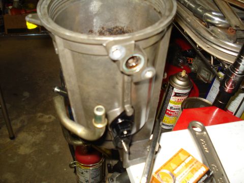 1994 Ford F-350 - Close-up of an engine intake manifold, showing internal debris and surrounding tools and supplies.