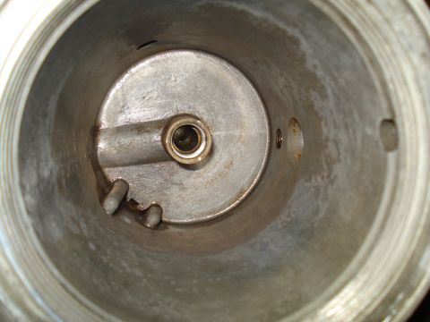 1994 Ford F-350 - Close-up view of the interior of a carburetor, revealing its internal components and some signs of wear.