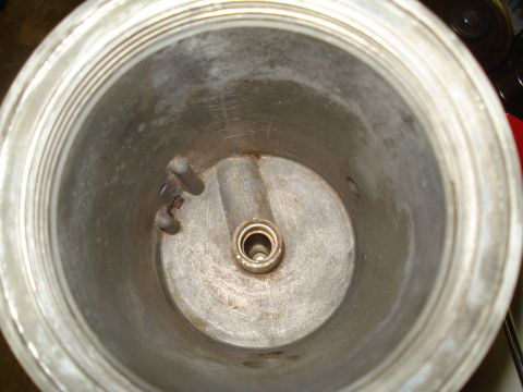 1994 Ford F-350 - Close-up view of the inside of a metal canister, showing a central spindle and threaded rim. Text at bottom reads SUPERMOTORS.NET.