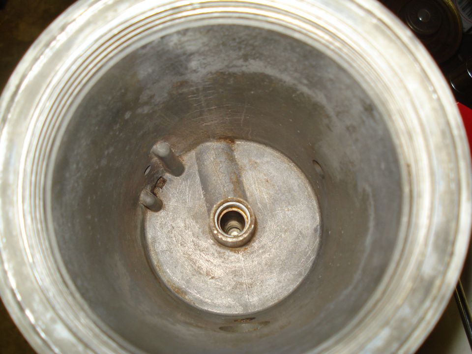 Interior of metal canister with central spindle and threaded rim