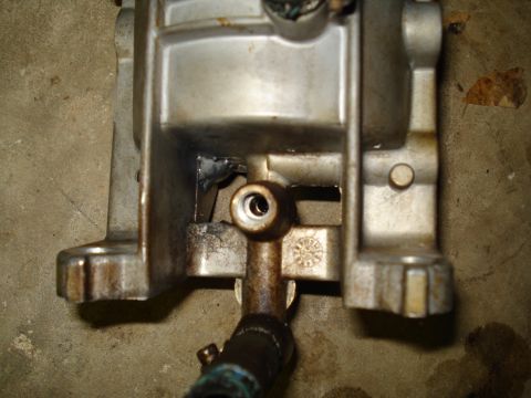 1994 Ford F-350 - This is a close-up view of a metal engine component with a hose attached.