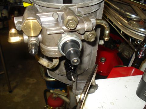 1994 Ford F-350 - Close-up of a carburetor assembly, showing various metal components and a black sensor.
