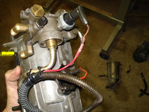 1994 Ford F-350 - Close-up of an engine component, likely a fuel pump or sensor, with various connections and wiring.