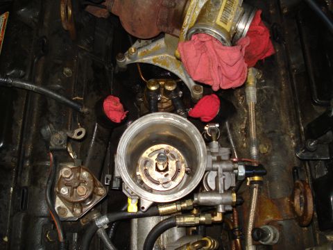 1994 Ford F-350 - Close-up of an engine's fuel filter housing, with red rags used to plug openings.