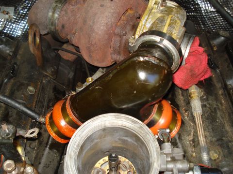 1994 Ford F-350 - Close-up view of engine components including a turbocharger and intake piping, with a red rag visible.