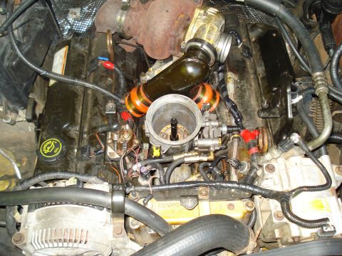 1994 Ford F-350 - Close-up view of an engine bay, showing the turbocharger and associated plumbing.