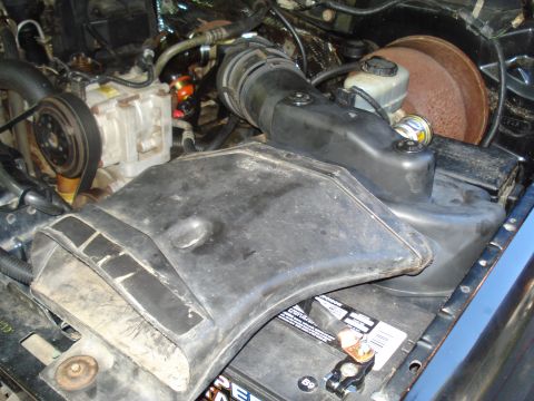 1994 Ford F-350 - Close-up view of a vehicle's engine compartment, showing the air intake system and battery.