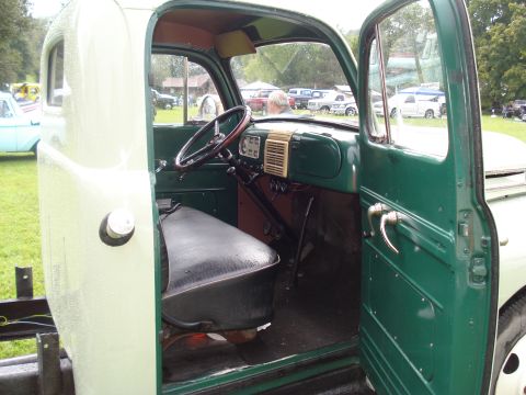 1994 Ford F-350 - Interior of a 1948 Ford F-1 pickup truck, with a man visible in the background.