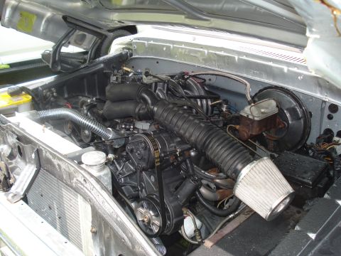 1994 Ford F-350 - Engine bay view of a V8 engine with aftermarket air intake and radiator.