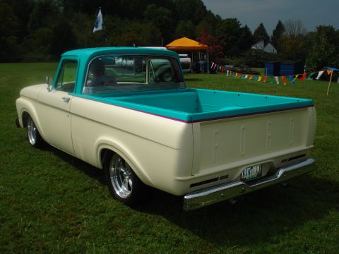1994 Ford F-350 - This two-tone pickup truck features a turquoise bed and cab trim, with chrome accents and custom wheels.