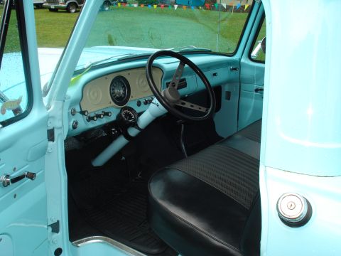 1994 Ford F-350 - Interior view of a classic light blue pickup truck, showing the dashboard and driver's seat.