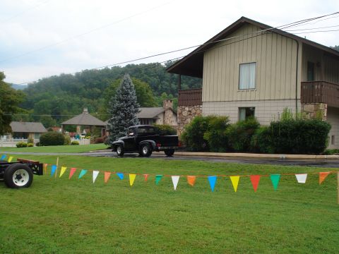 1994 Ford F-350 - A vintage black pickup truck is parked on the side of the road near a house.