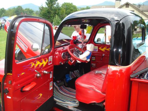 1994 Ford F-350 - Customized red pickup truck interior flame decals and a teddy bear accessory on the steering wheel.