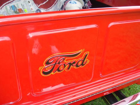1994 Ford F-350 - Close-up of a red Ford truck's tailgate the classic script logo. Text from a watermark is also visible.