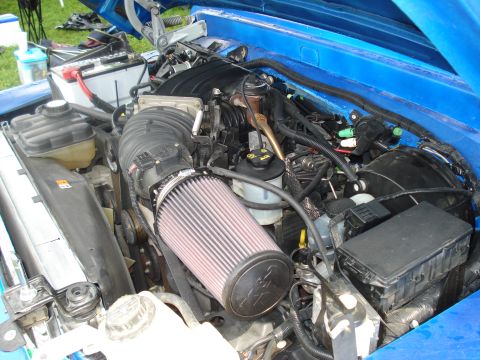 1994 Ford F-350 - Close-up view of a modified engine bay with an aftermarket air intake system installed.