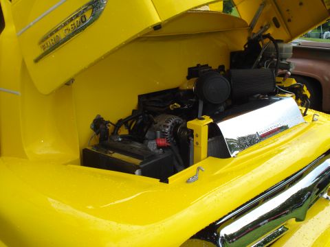 1994 Ford F-350 - Engine bay of a yellow Ford F-series truck, a 'POWER STROKE' cover and 'FORD F600' badging, suggesting an earlier model than claimed.