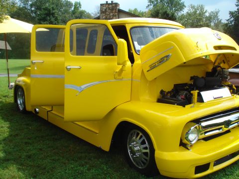 1994 Ford F-350 - This custom pickup truck features a two-tone paint scheme and a prominent engine bay.
