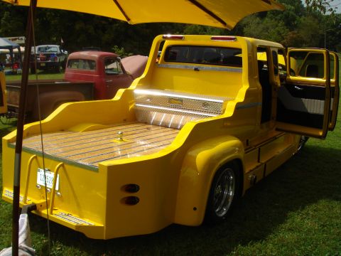 1994 Ford F-350 - Custom yellow pickup truck with a wooden bed and a diamond plate toolbox is parked outdoors.