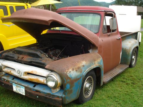 1994 Ford F-350 - This vintage Ford pickup truck, likely a 1953 model, is shown with its hood up, revealing the engine compartment.