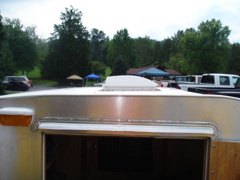 1994 Ford F-350 - A view of a trailer's roof, a vent and an orange marker light, with several trucks visible in the background.
