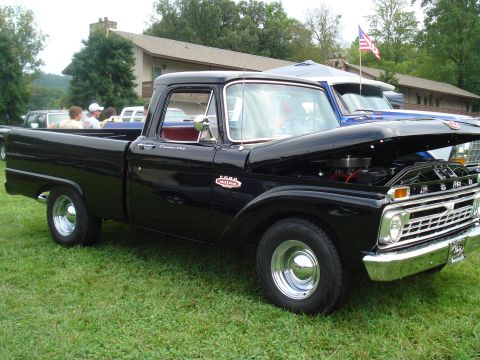 1994 Ford F-350 - Black Ford pickup truck with hood open, parked on grass at an outdoor event.