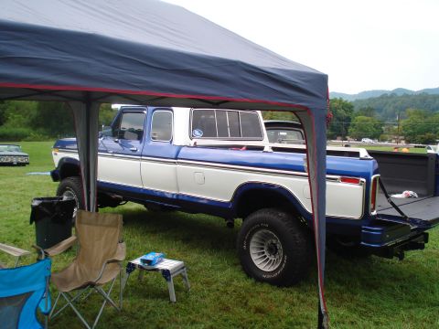 1994 Ford F-350 - A two-tone blue and white Ford pickup truck, likely from the late 1970s, is parked outdoors under a blue canopy.