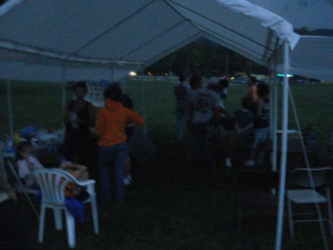 1994 Ford F-350 - Gathering under a tent at an outdoor event during twilight.
