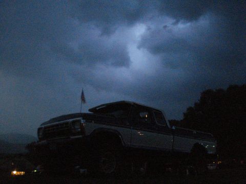1994 Ford F-350 - Pickup truck under a dark, stormy sky with an American flag.
