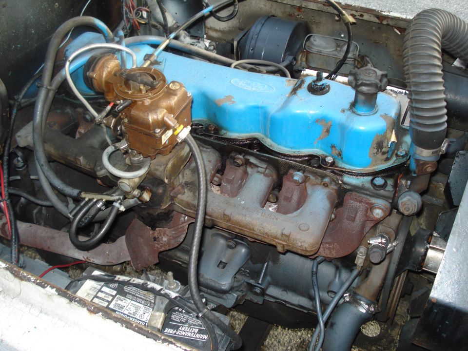 Ford V8 engine with blue valve covers and a carburetor