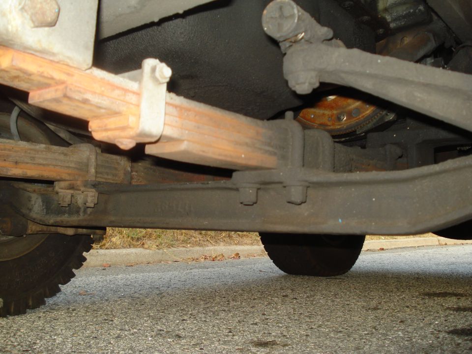 Undercarriage view of truck leaf springs and suspension components