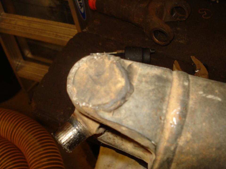Close-up of a driveshaft universal joint with a metal shaft protruding