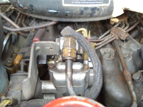 1984 Ford F-250 - Engine bay detail showing a fuel injection pump and associated plumbing. Text on a nearby label mentions Motorcraft parts.