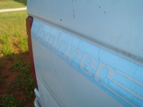 1984 Ford F-250 - A close-up shot shows the "Explorer" decal on the side of a vehicle, with visible cracking on the decal's surface.