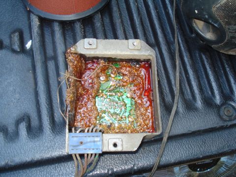 1984 Ford F-250 - This electronic control module shows significant corrosion and damage to its internal components.