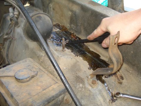 1984 Ford F-250 - Scraping dried fluid from engine bay components.