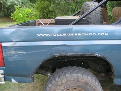 1986 Ford Bronco - The rear quarter panel of a Ford Bronco shows damage and the website WWW.FULLSIZEBRONCO.COM.