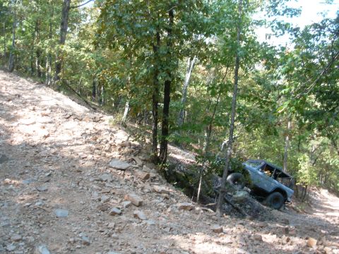 1983 Ford Bronco - Ford Bronco tackling a challenging off-road path on a sunny day.