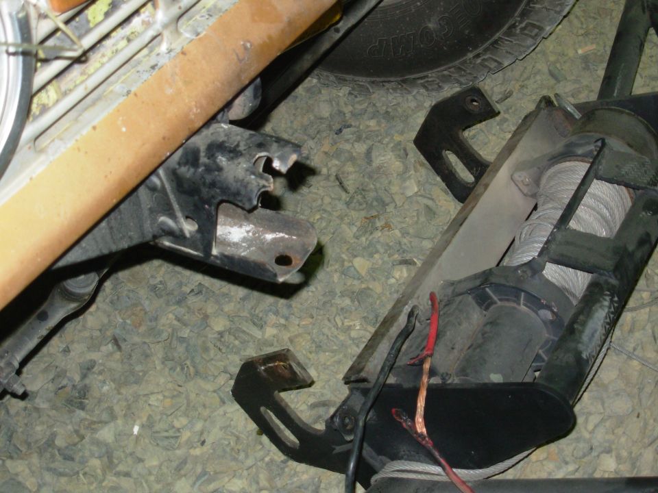 This ripped out because there was no clamping force between the bolt, frame, & bumper.  The vertical bolt simply passed through the bumper & frame.  Fortunately, when it ripped loose, the bumper stayed attached by the lower hole & the rear bolts, and the fire from the hot wire was limited to the wire's insulation.  This could easily have been MUCH worse...

He got the worst break award, despite some TOUGH contenders.