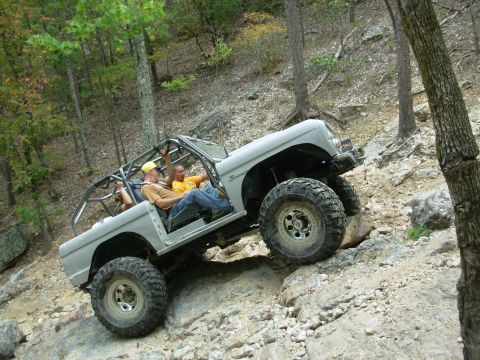1983 Ford Bronco - This modified 1983 Ford Bronco navigates a rocky trail with its occupants enjoying the off-road adventure.
