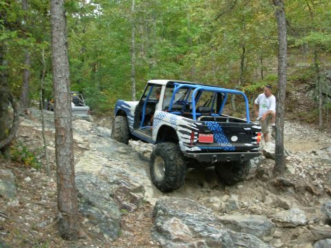 1983 Ford Bronco - A modified 1983 Ford Bronco navigates a rocky trail with another vehicle visible in the background.