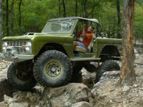 1983 Ford Bronco - Modified Ford Bronco tackling a challenging rocky off-road course.