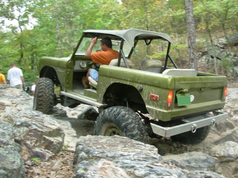 1983 Ford Bronco - A man drives a vintage Ford Bronco through a rocky off-road course.