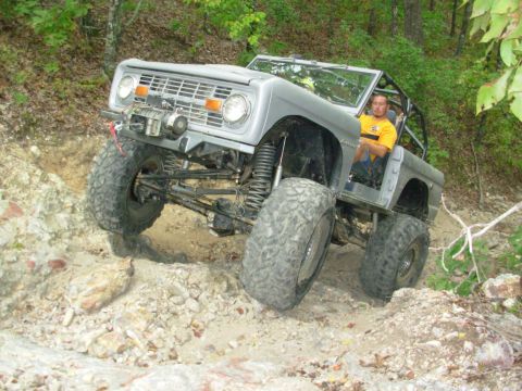 1983 Ford Bronco - This heavily modified Ford Bronco is tackling a challenging off-road course.