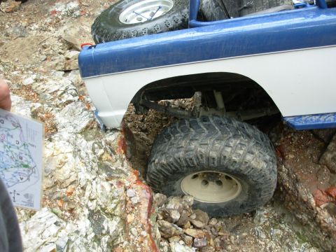 1983 Ford Bronco - Off-road vehicle navigates difficult rocky terrain, with a map being consulted for guidance.
