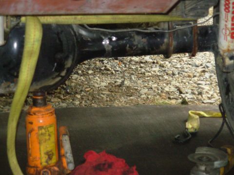 1983 Ford Bronco - The axle tube broke all the way around. He's ratchet-strapping back together so it can be welded up. The jack is holding it aligned.