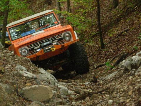 1983 Ford Bronco - First-gen Ford Bronco navigating a challenging rocky off-road course.